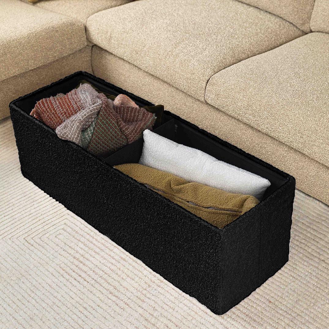 Large black ottoman storing blankets and pillows